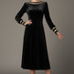 Model wearing the diva catwalk Spinetti long-sleeved jewelled velvet midi dress in black.