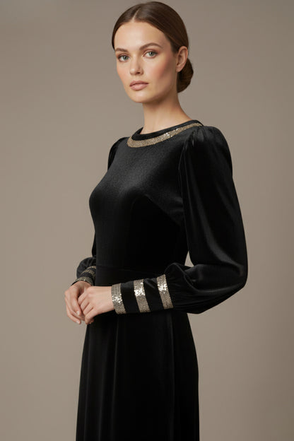 Model wearing the diva catwalk Spinetti long-sleeved jewelled velvet midi dress in black side close up