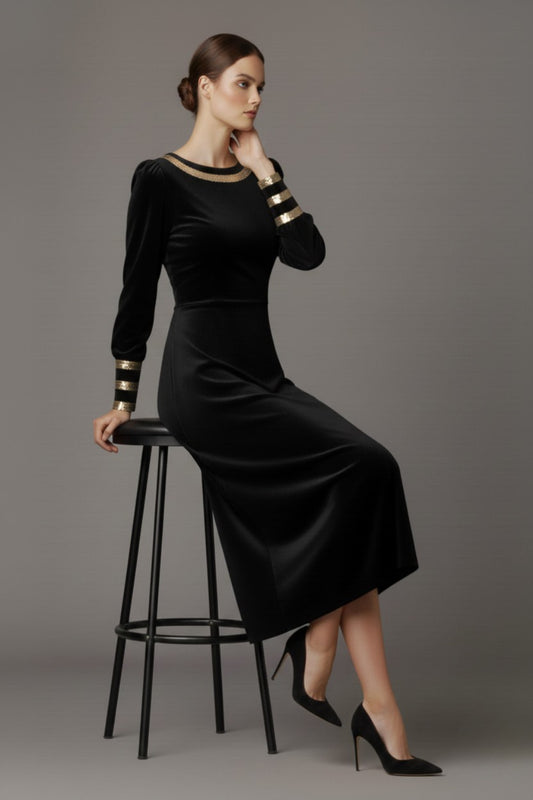 Woman wearing a black dress with gold accents sitting on a stool against a beige background (Black Velvet with Sherwood Glitter Contrast)