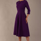 Side view of the Perpetua A-line dress in deep purple, showing the 3/4 sleeves and midi skirt (Deep Purple)
