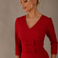 Close-up of the elegant V-neckline and double-bow detail on the Corniche dress in dark red (Dark Red)