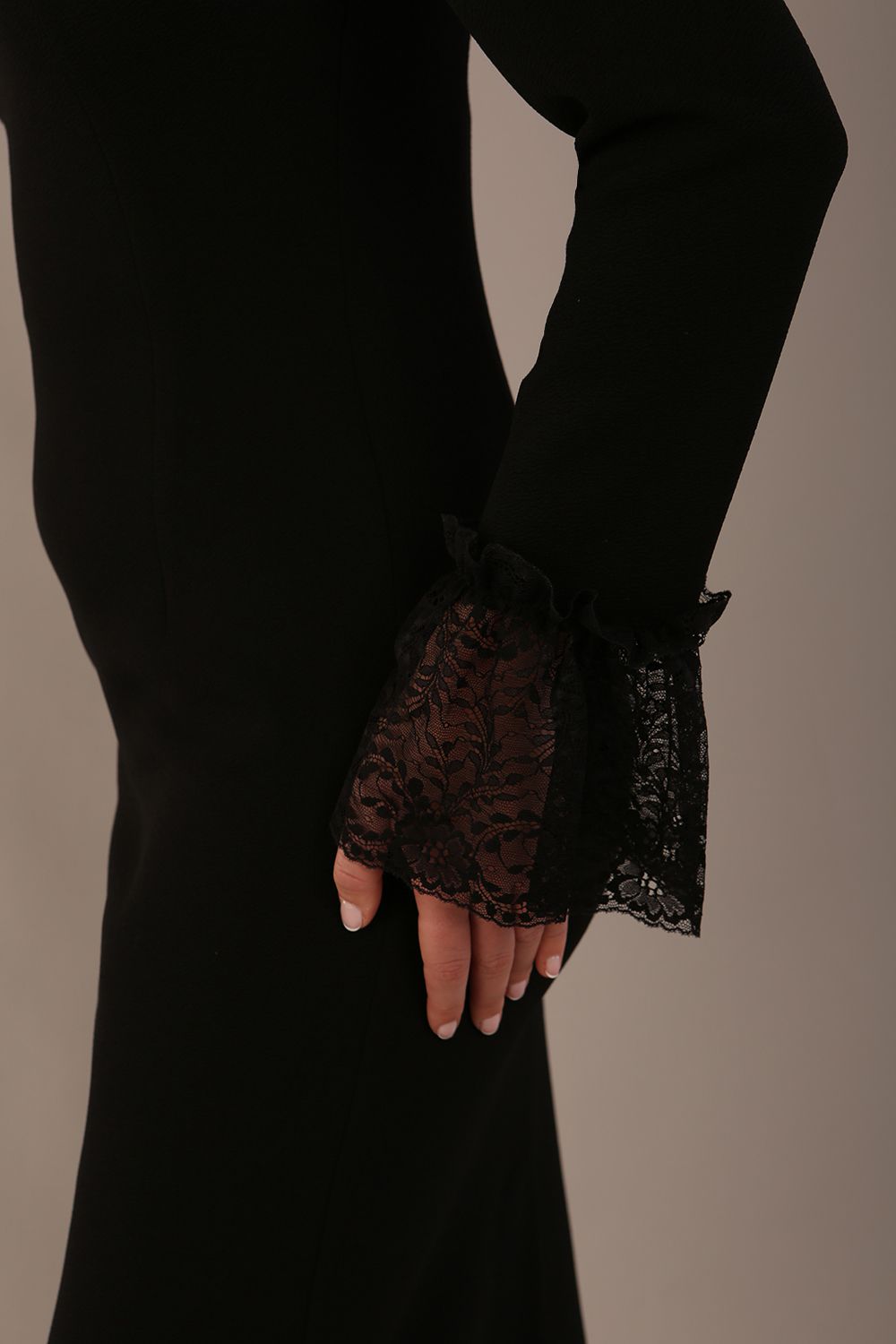 Close-up of the lace appliqué on the shoulder of the Holby dress (Black)