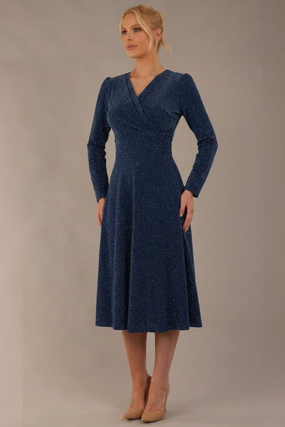 Model wearing the Calvert sparkle A-line dress in burgundy, showing the wrap V-neckline (Teal Sparkle)