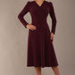 Model wearing the Calvert sparkle A-line dress in burgundy, showing the wrap V-neckline (Burgundy Sparkle)