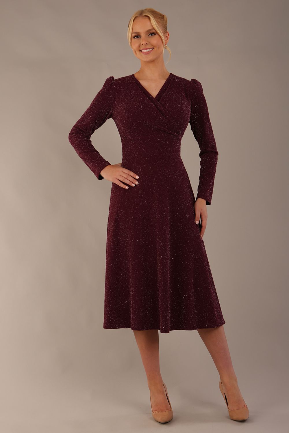 Model wearing the Calvert sparkle A-line dress in burgundy, showing the wrap V-neckline (Burgundy Sparkle)