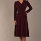 Model wearing the Calvert sparkle A-line dress in burgundy, showing the wrap V-neckline (Burgundy Sparkle)