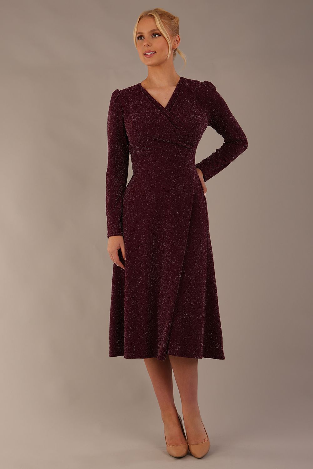 Model wearing the Calvert sparkle A-line dress in burgundy, showing the wrap V-neckline (Burgundy Sparkle)