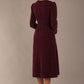 Model wearing the Calvert sparkle A-line dress in burgundy, Back view of the Calvert sparkle midi dress, showing the gathered waistband and clean silhouette. (Burgundy Sparkle)