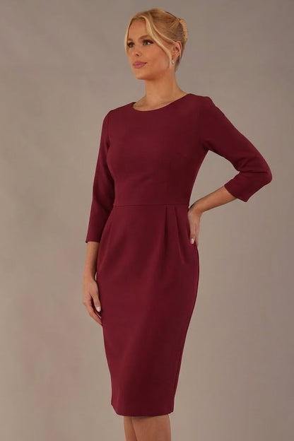 Model wearing the Makepiece tulip skirt tailored dress in wine, featuring an elegant boat neckline (Wine)