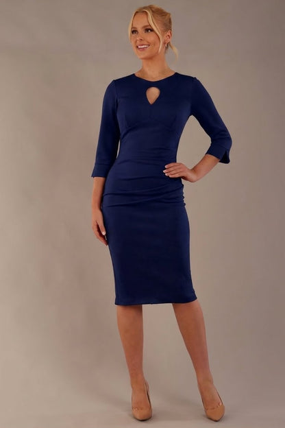 Model wearing the diva catwalk Yasmeen pencil dress in navy blue, featuring a teardrop keyhole neckline (Navy Blue)