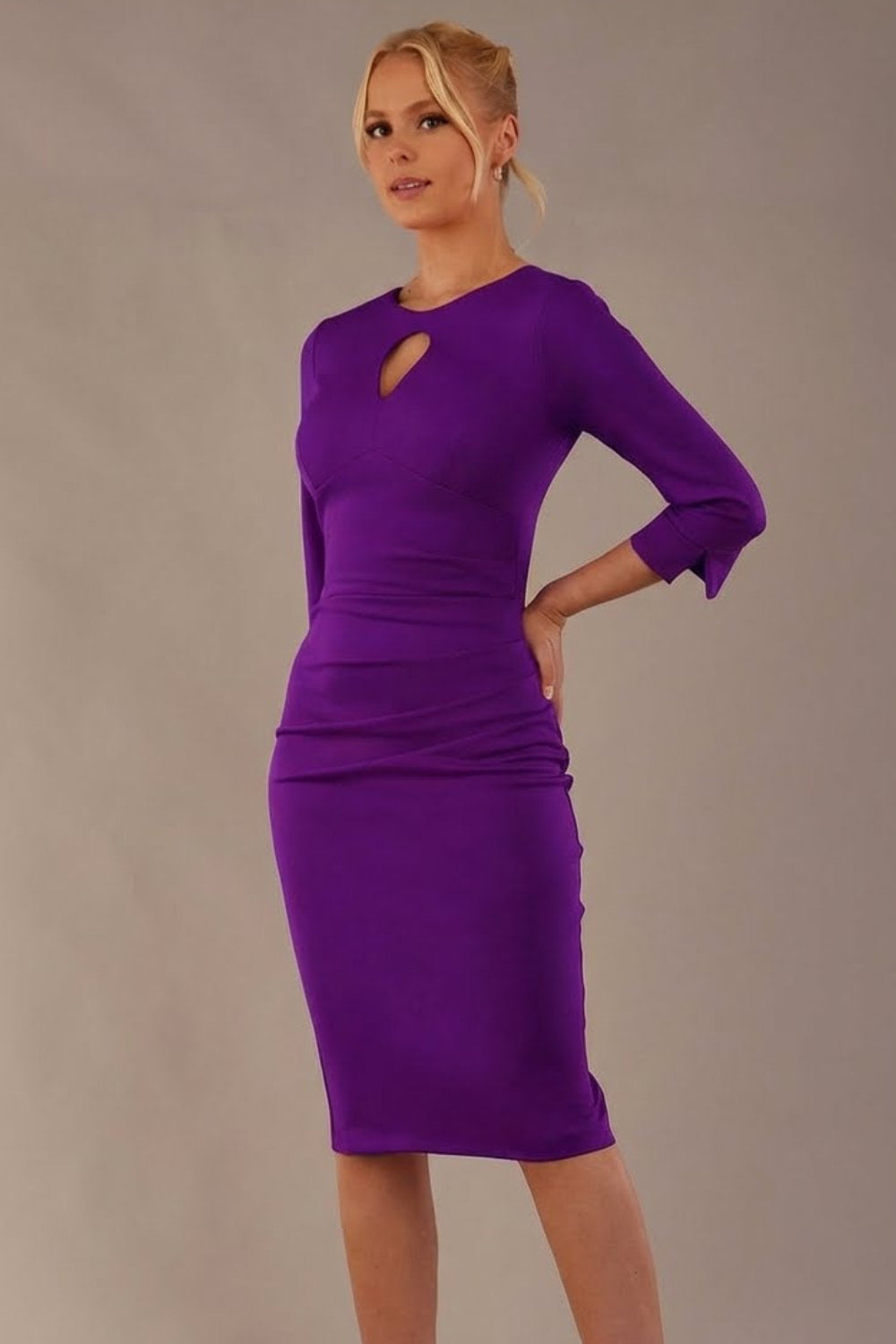 Model wearing the diva catwalk Yasmeen pencil dress in passion purple, featuring a teardrop keyhole neckline (Passion Purple)
