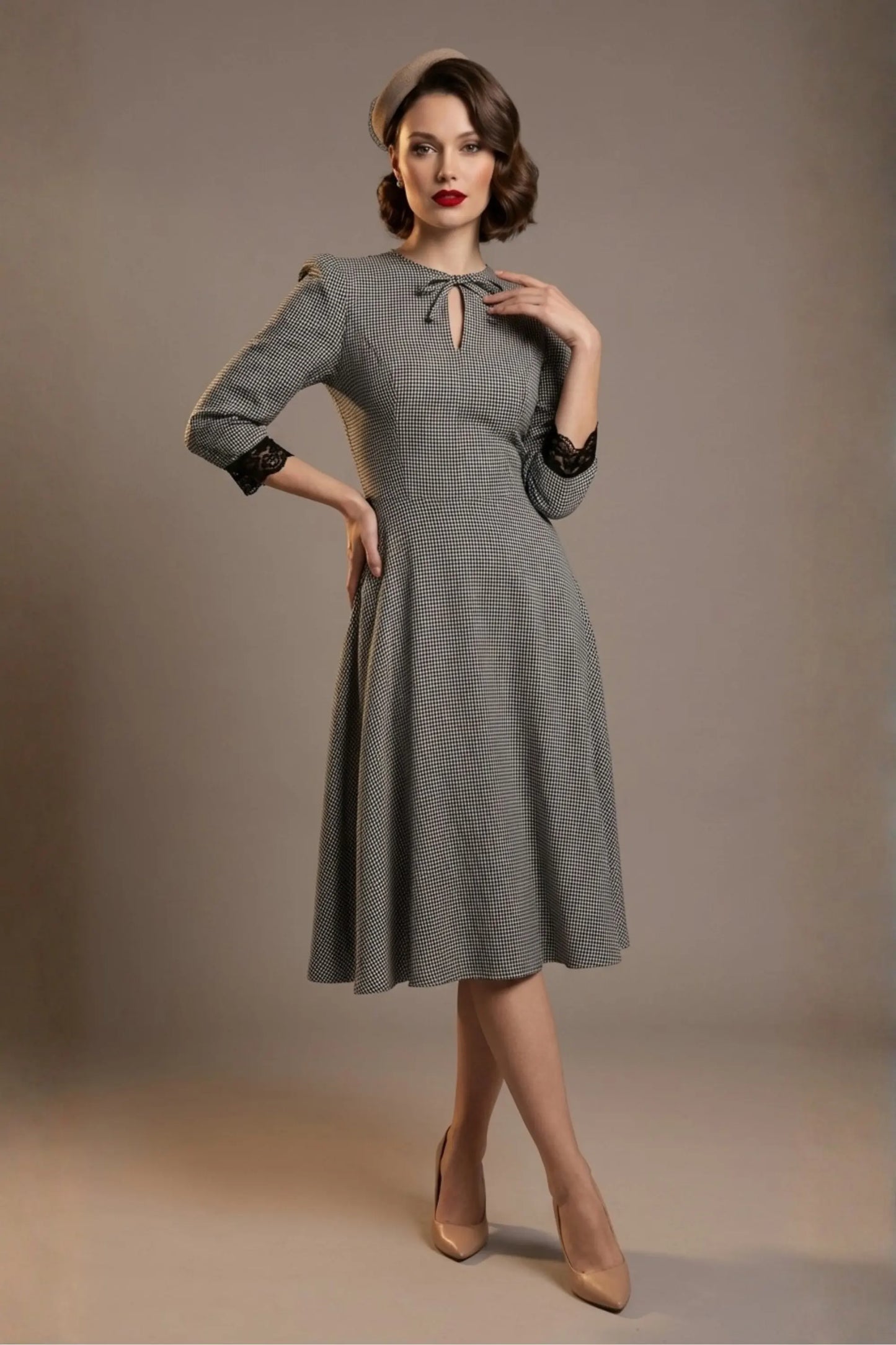 Woman wearing a diva catwalk Alanna Dogtooth Tie-Detail A-Line Dress | Diva Catwalk with long sleeves against a plain background (Petite Dogtooth Check)