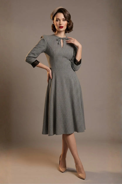 Woman wearing a diva catwalk Alanna Dogtooth Tie-Detail A-Line Dress | Diva Catwalk with long sleeves against a plain background (Petite Dogtooth Check)