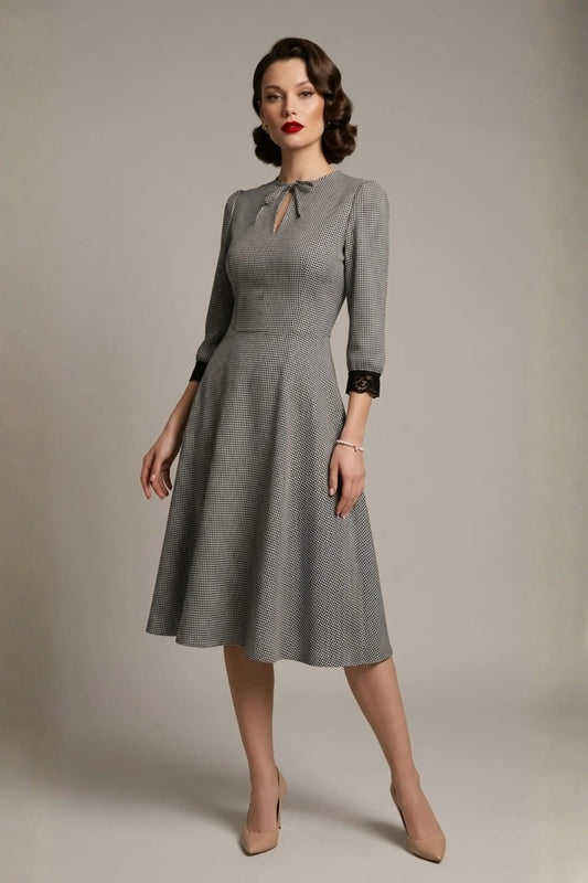 Woman wearing a diva catwalk Alanna Dogtooth Tie-Detail A-Line Dress | Diva Catwalk with long sleeves against a plain background (Petite Dogtooth Check)