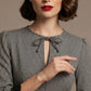Woman wearing a diva catwalk Alanna Dogtooth Tie-Detail A-Line Dress | Diva Catwalk with long sleeves against a plain background close up (Petite Dogtooth Check)