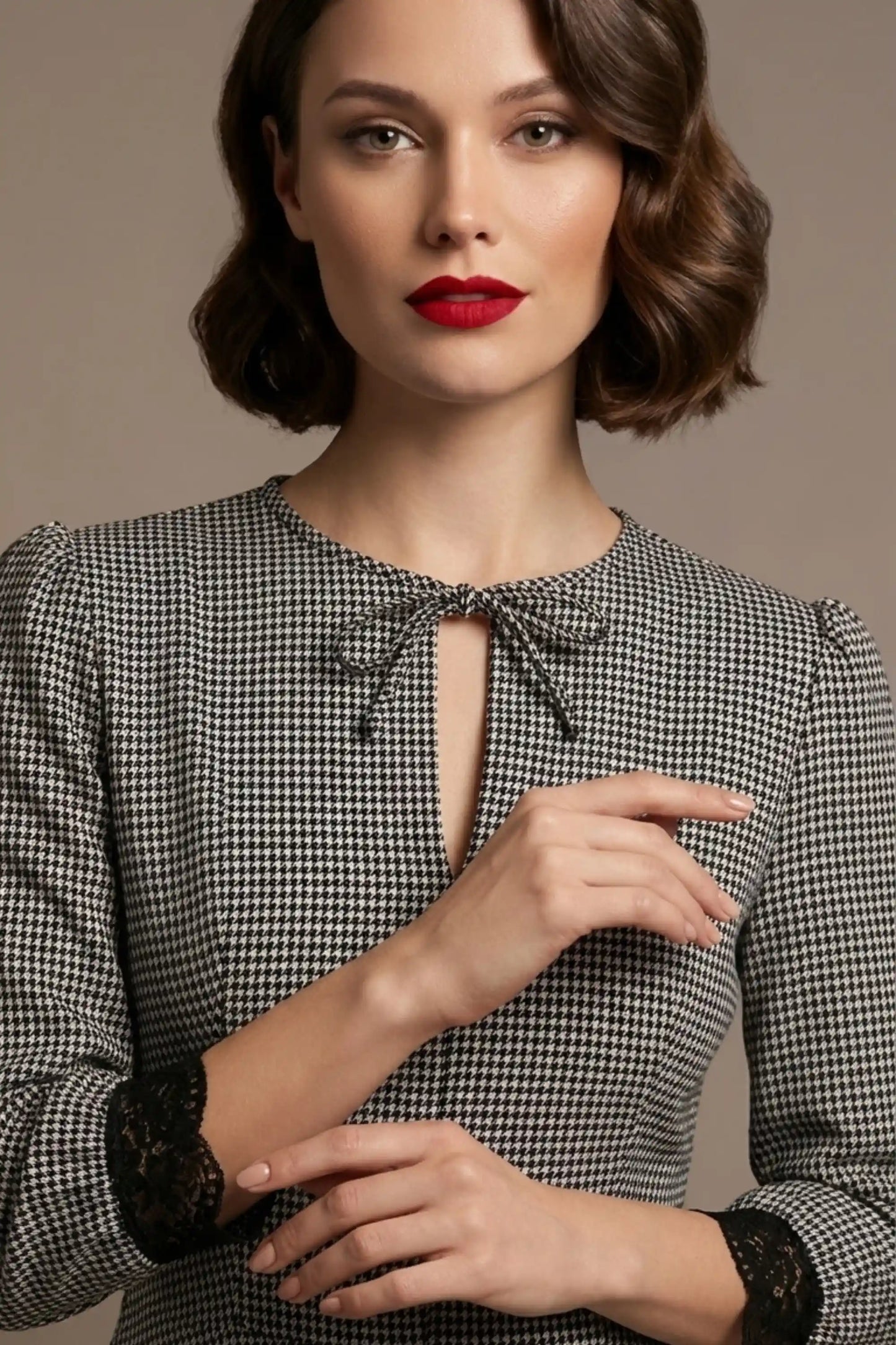 Woman wearing a diva catwalk Alanna Dogtooth Tie-Detail A-Line Dress | Diva Catwalk with long sleeves against a plain background close up (Petite Dogtooth Check)