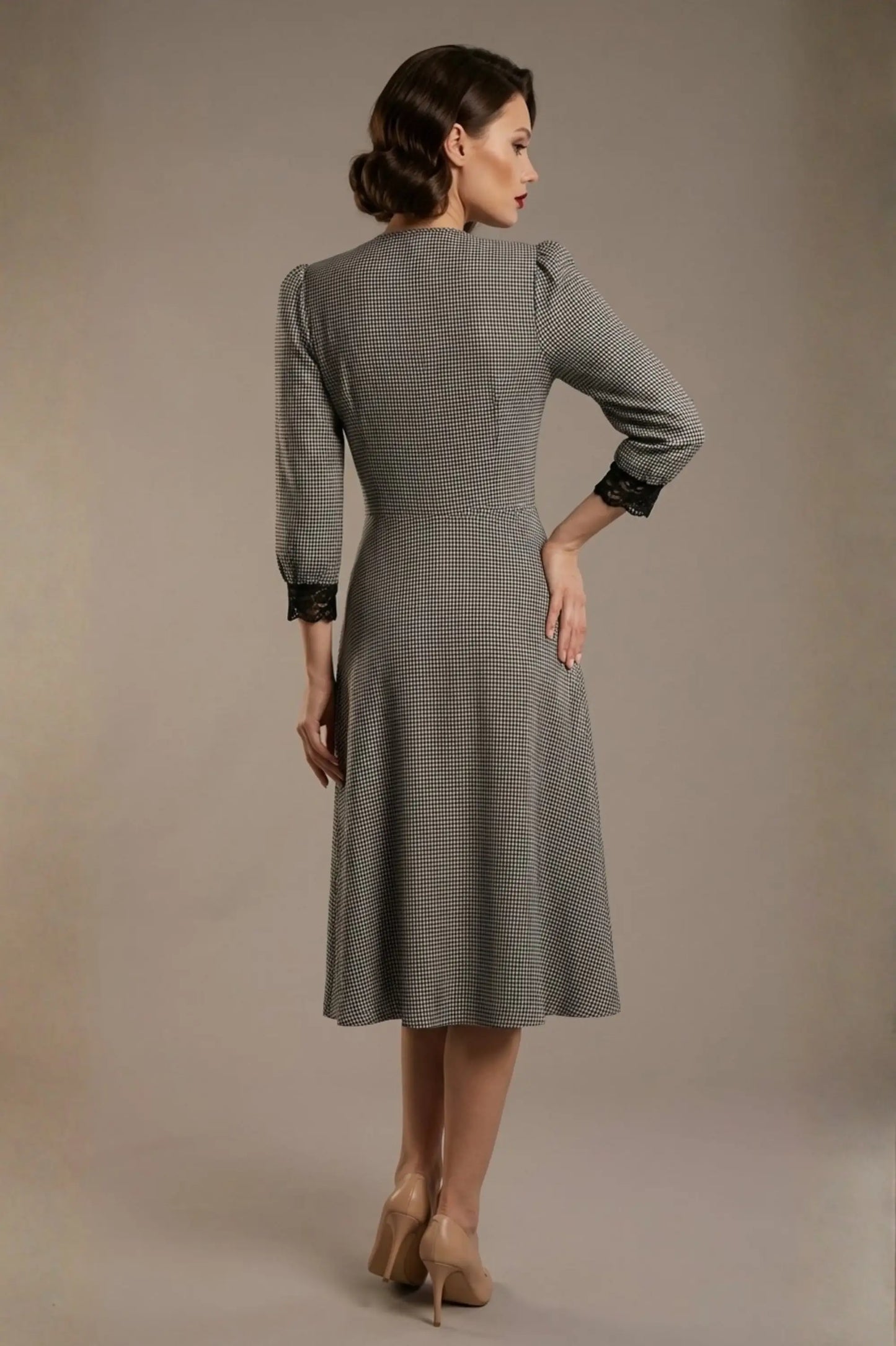 Woman wearing a diva catwalk Alanna Dogtooth Tie-Detail A-Line Dress | Diva Catwalk with long sleeves against a plain background back view (Petite Dogtooth Check)