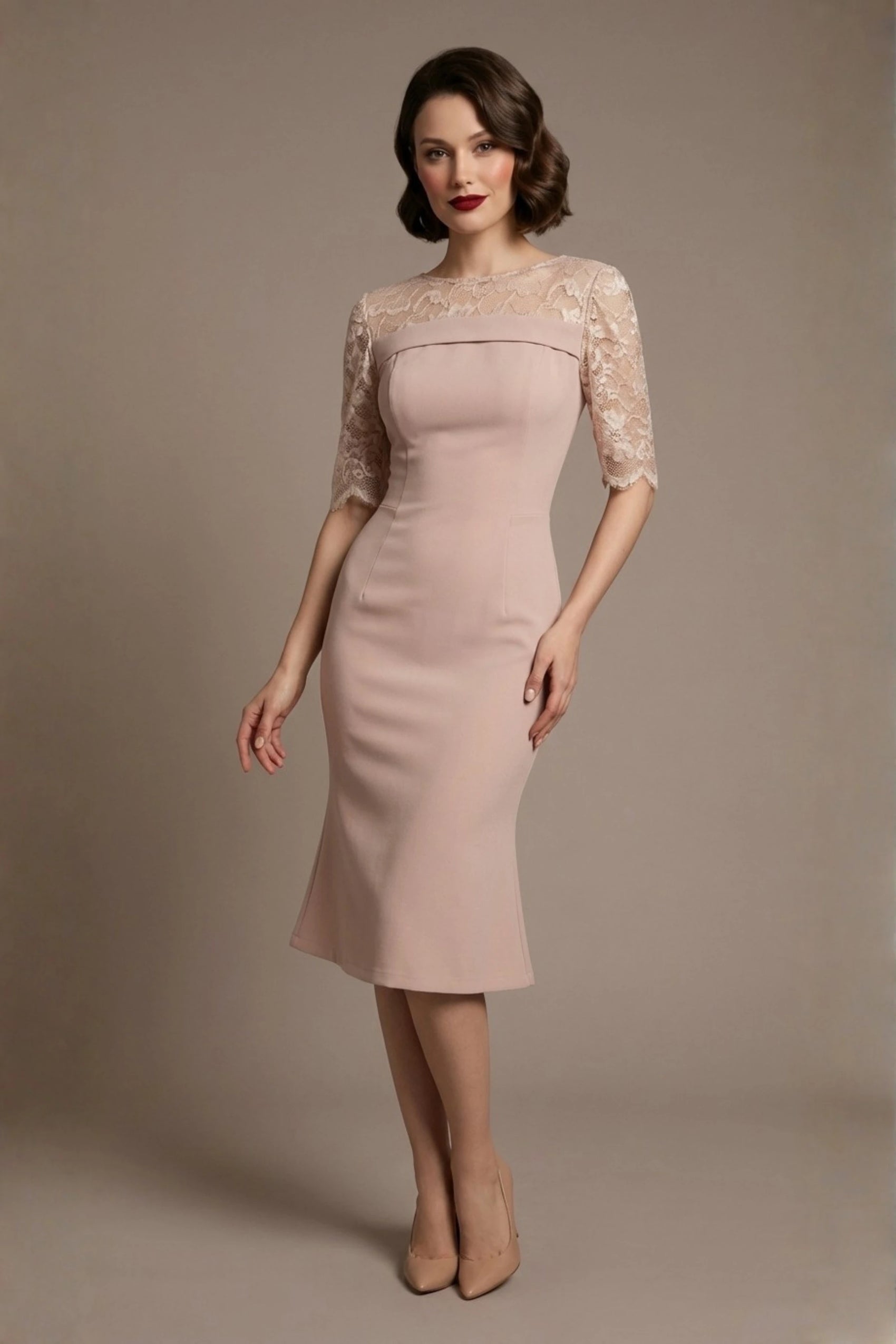 Woman wearing a diva catwalk Francesca Lace Fluted Dress in pink haze colour dress with lace sleeves against a brown background (Pink Haze)
