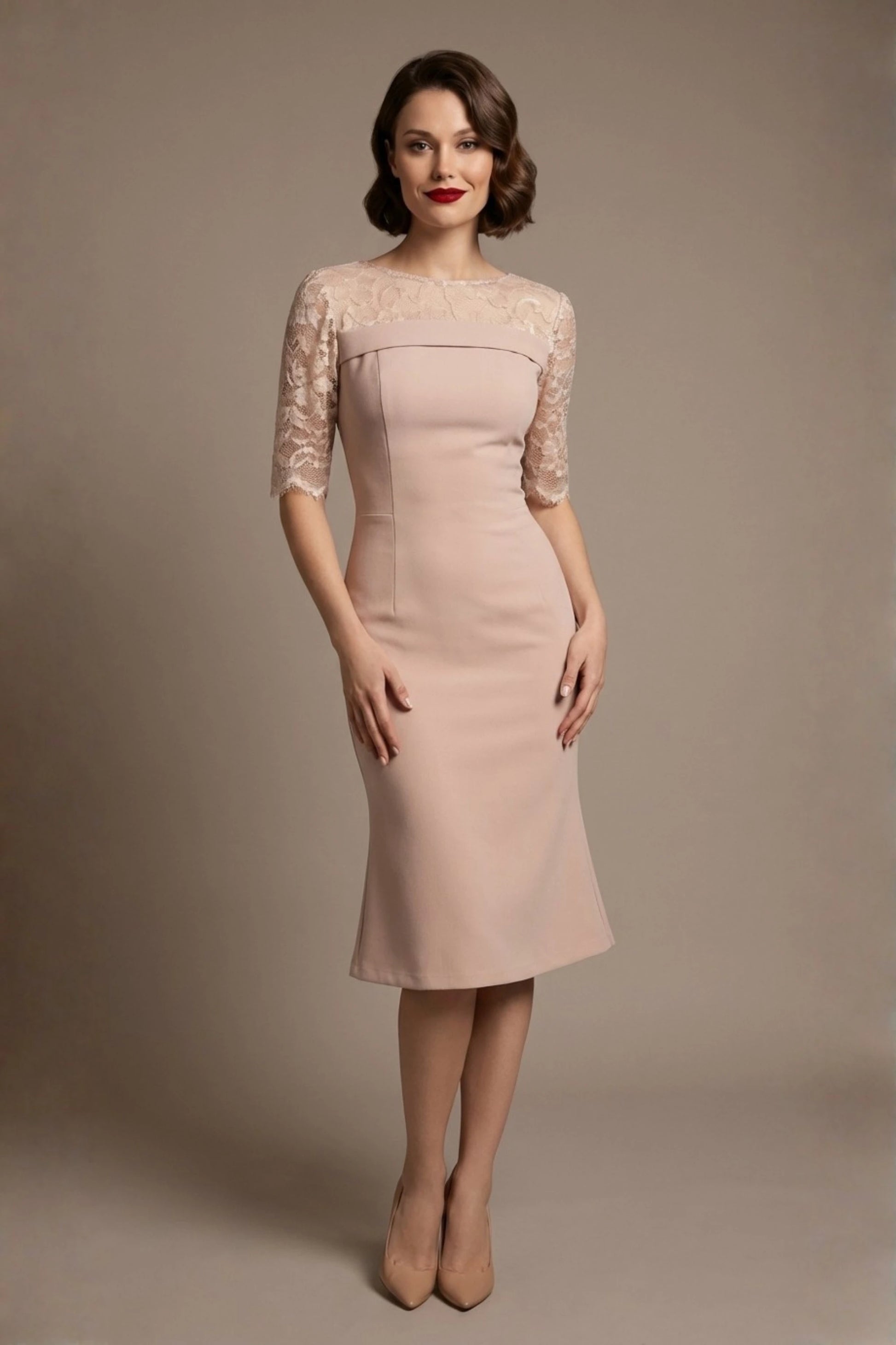 Woman wearing a diva catwalk Francesca Lace Fluted Dress in pink haze colour dress with lace sleeves against a brown background front view (Pink Haze)