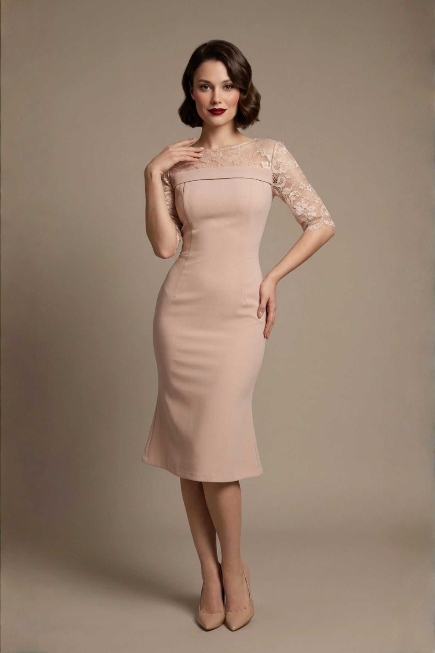 Woman wearing a diva catwalk Francesca Lace Fluted Dress in pink haze colour dress with lace sleeves against a brown background front (Pink Haze)