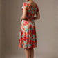 Woman wearing a diva catwalk colorful floral dress called Valia Silk Touch A-Line Dress against a plain background (Floral Dream Print)