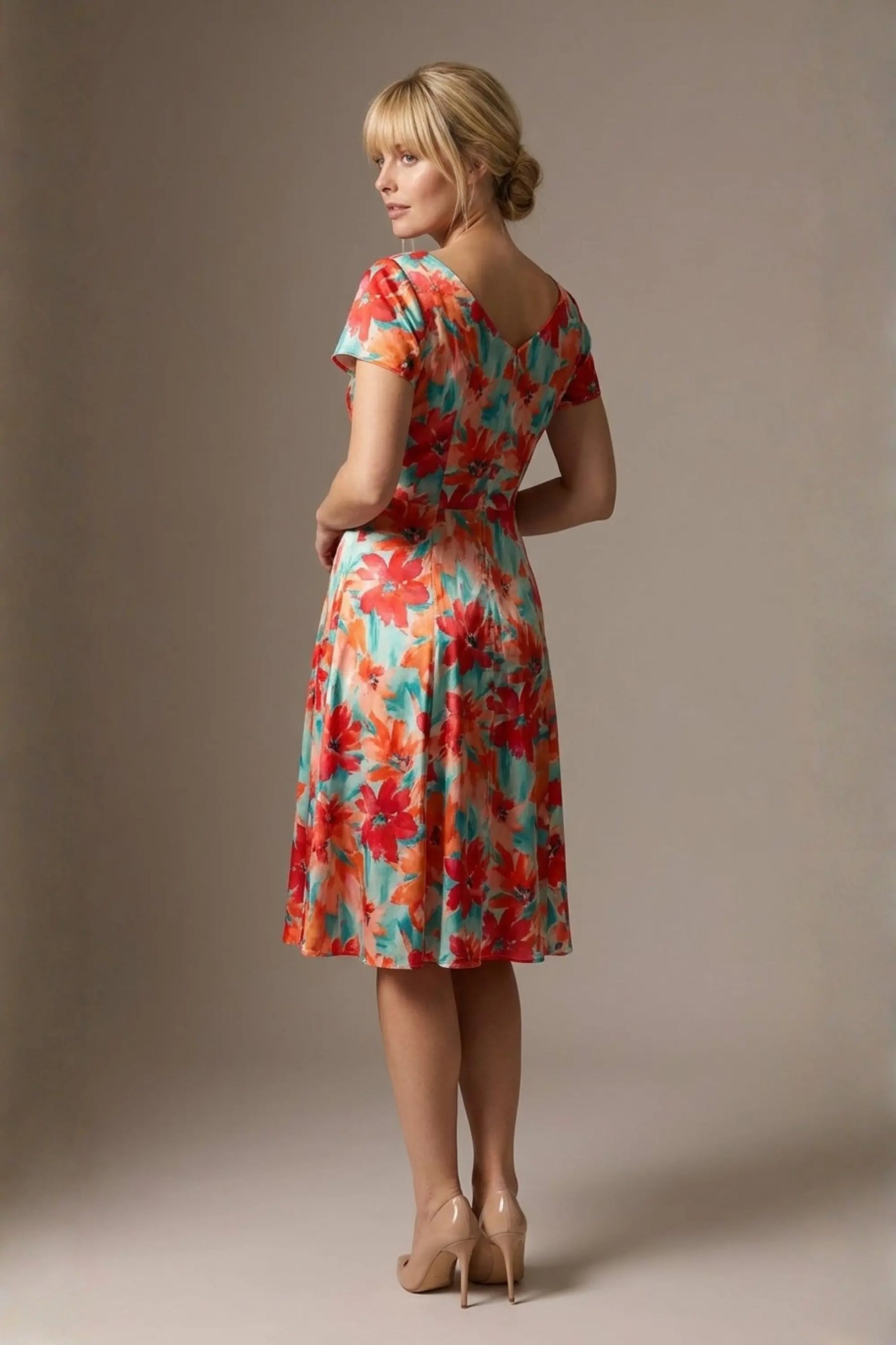Woman wearing a diva catwalk colorful floral dress called Valia Silk Touch A-Line Dress against a plain background (Floral Dream Print)