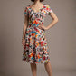 Woman wearing a diva catwalk colorful floral dress called Valia Silk Touch A-Line Dress against a plain background (Erratic Leaf Print)
