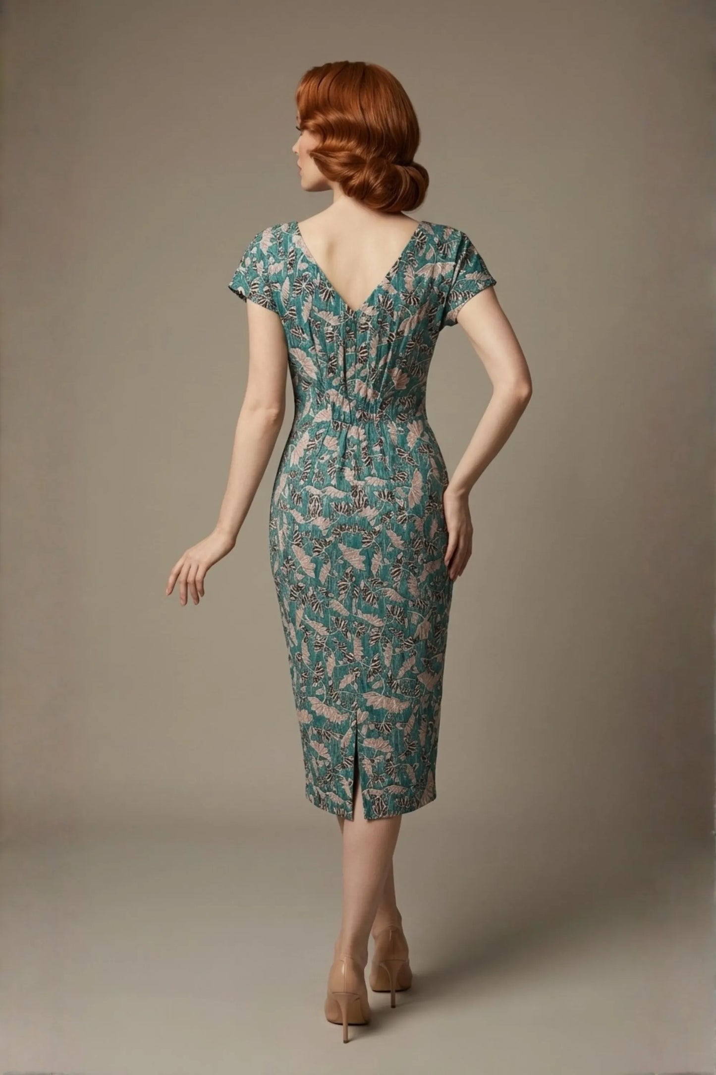 Woman wearing a diva catwalk Magritte Vintage Floral Cotton Pencil Dress, floral dress against a plain background (Vintage Floral Print)