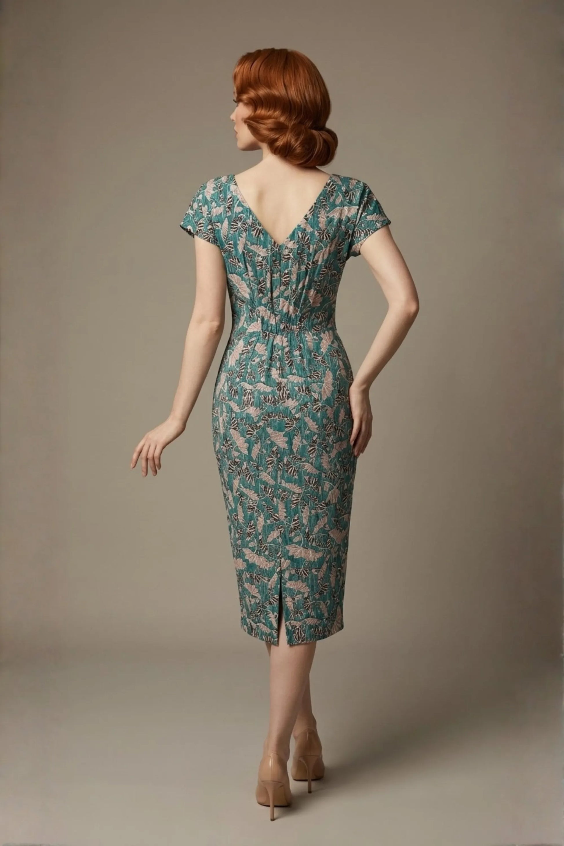 Woman wearing a diva catwalk Magritte Vintage Floral Cotton Pencil Dress, floral dress against a plain background (Vintage Floral Print)