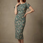 Woman wearing a diva catwalk Magritte Vintage Floral Cotton Pencil Dress, floral dress against a plain background (Vintage Floral Print)