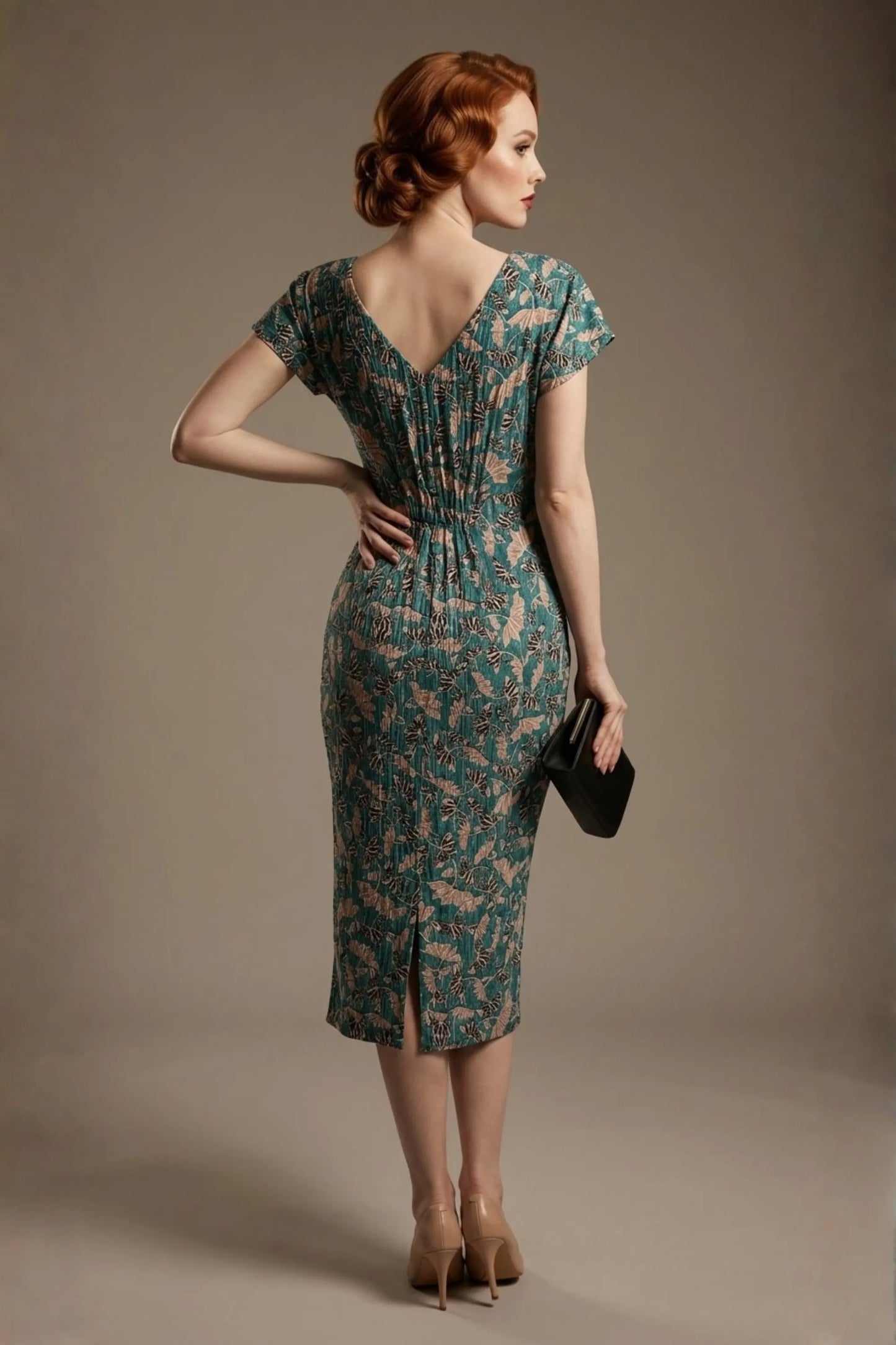 Woman wearing a diva catwalk Magritte Vintage Floral Cotton Pencil Dress, floral dress against a plain background (Vintage Floral Print)