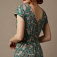 Woman wearing a diva catwalk Magritte Vintage Floral Cotton Pencil Dress, floral dress against a plain background (Vintage Floral Print)