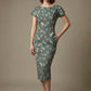 Woman wearing a diva catwalk Magritte Vintage Floral Cotton Pencil Dress, floral dress against a plain background (Vintage Floral Print)