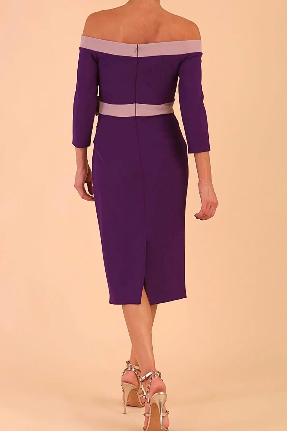 Model wearing a diva catwalk Brittany Off Shoulder Bow detail Pencil Dress with 3/4 sleeves and knee length in Deep Purple and Thunder Bird colour back