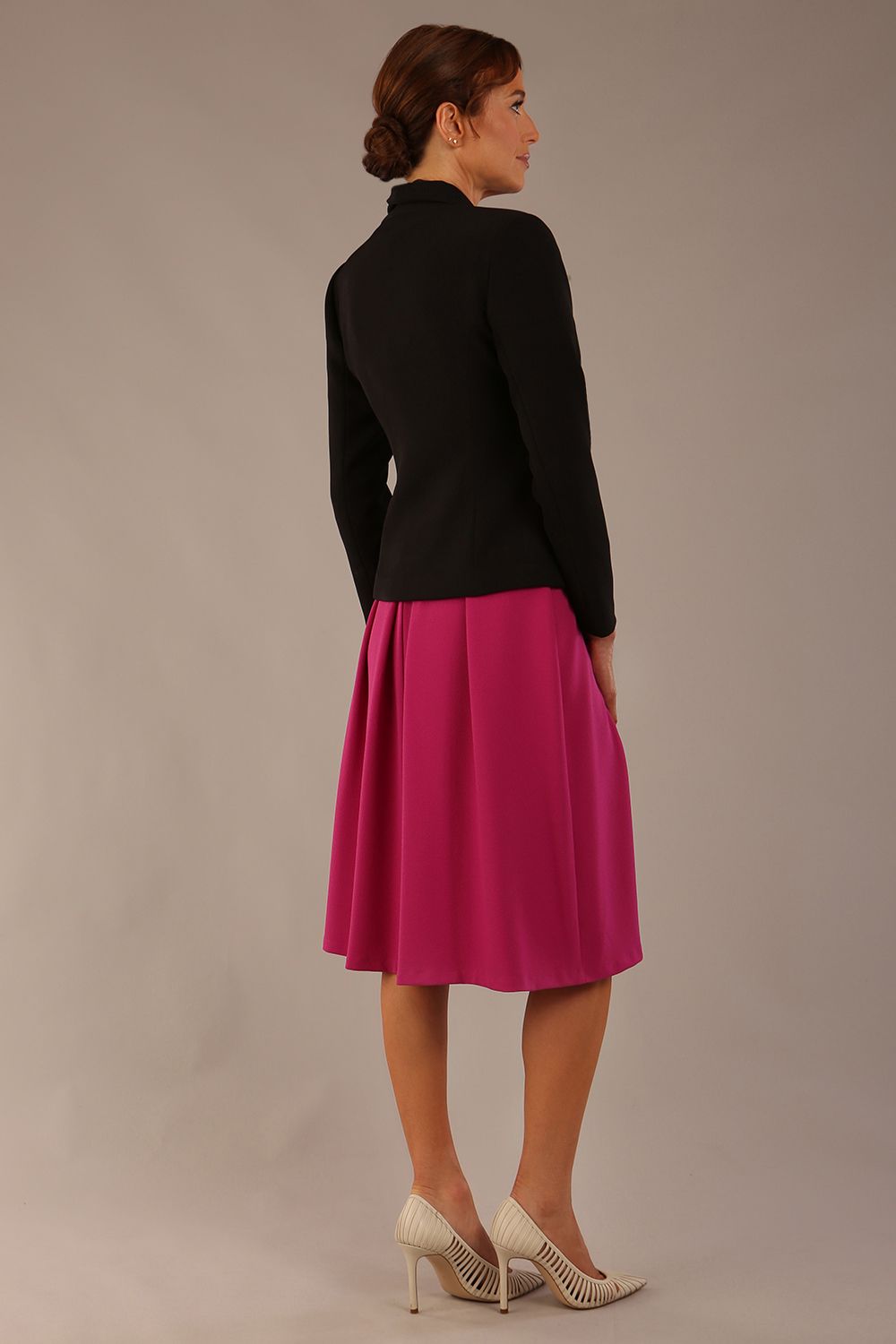 back view of the Model wearing the Melberry tailored jacket in black, showing the sculpted waist and statement lapel detail.