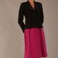 Model wearing the Melberry tailored jacket in black, showing the sculpted waist and statement lapel detail.