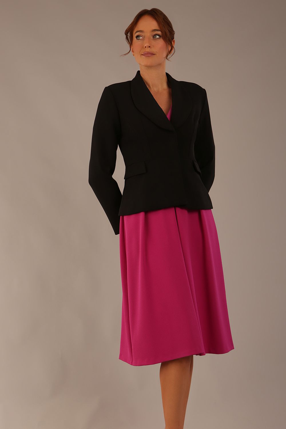 Model wearing the Melberry tailored jacket in black, showing the sculpted waist and statement lapel detail.