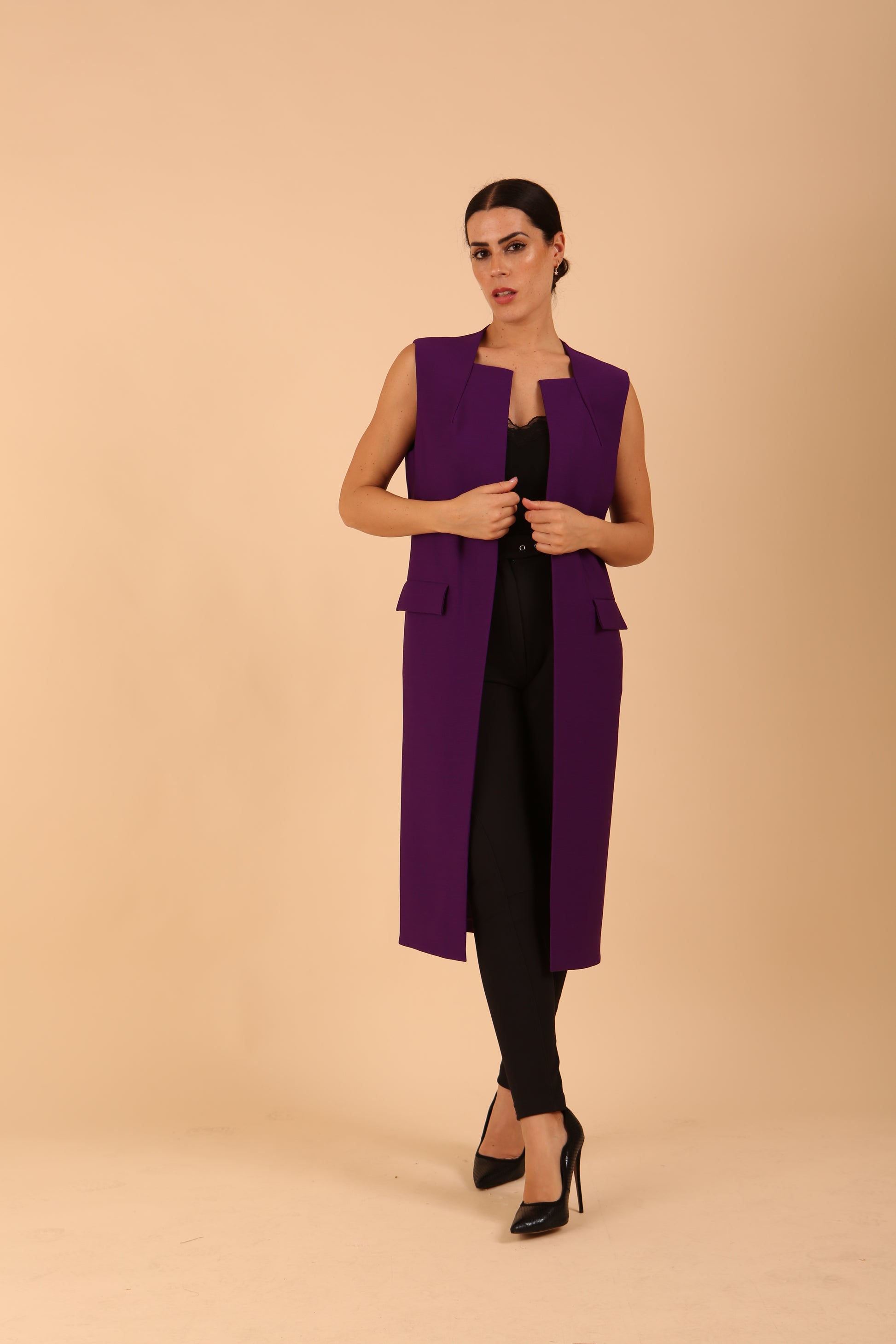 model wearing a divacatwalk Seed Harvard Sleeveless Coat midi length in imperial purple colour front