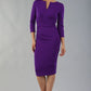 model is wearing diva catwalk donna sleeved pencil dress in passion purple front