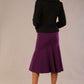 Model wearing a purple Marlene fishtail skirt, highlighting the silhouette with an elegant DIVA black jacket