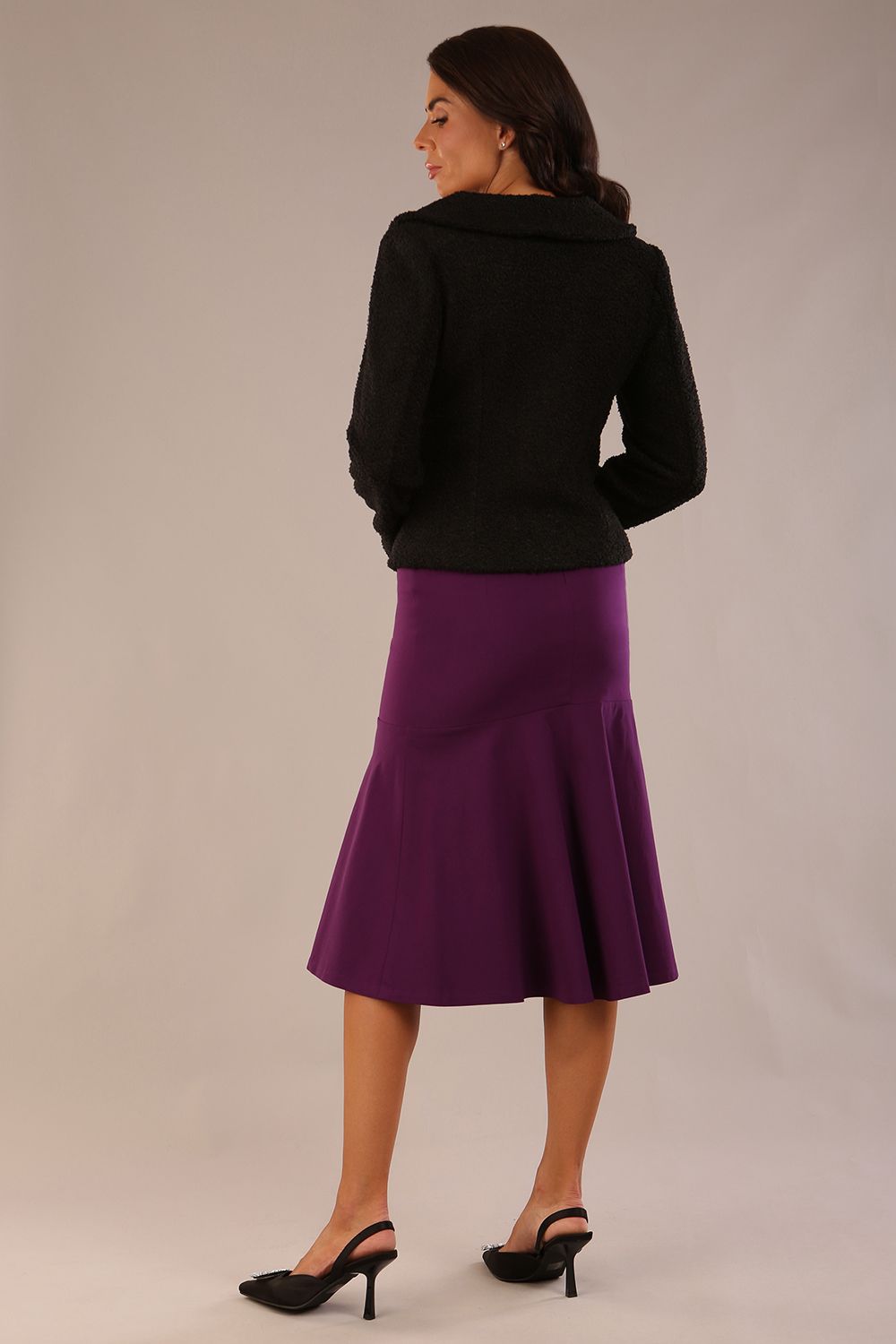 Model wearing a purple Marlene fishtail skirt, highlighting the silhouette with an elegant DIVA black jacket