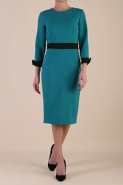 Model wearing diva catwalk Reese 3/4 Sleeved pencil skirt dress with a contrast sleeve and waistband details in Parasailing Green