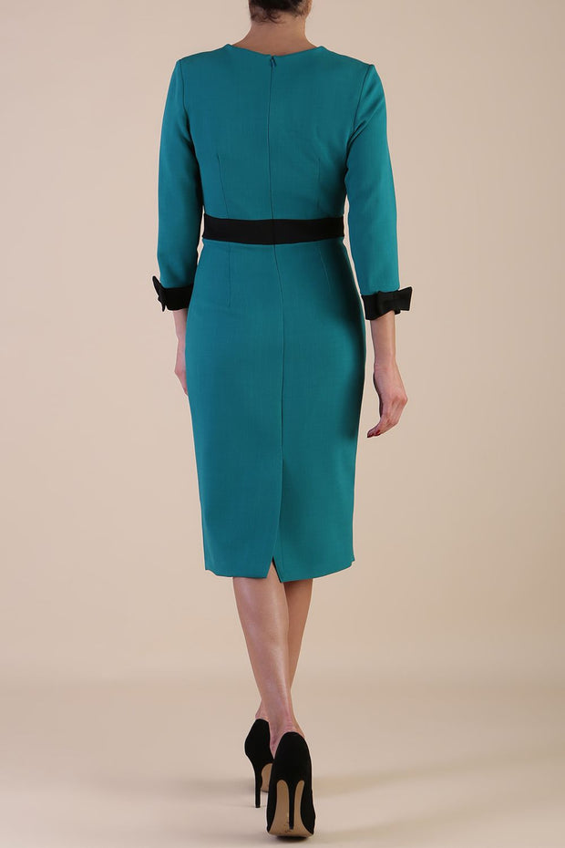 Model wearing diva catwalk Reese 3/4 Sleeved pencil skirt dress with a contrast sleeve and waistband details in Parasailing Green