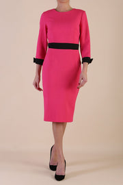 Model wearing diva catwalk Reese 3/4 Sleeved pencil skirt dress with a contrast sleeve and waistband details in Fuschia Pink/Black