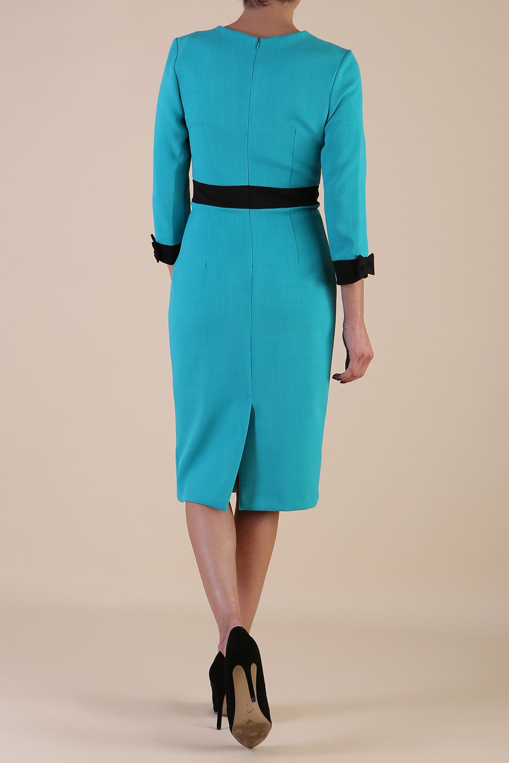 Model wearing diva catwalk Reese 3/4 Sleeved pencil skirt dress with a contrast sleeve and waistband details in Aqua Green/Black