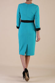 Model wearing diva catwalk Reese 3/4 Sleeved pencil skirt dress with a contrast sleeve and waistband details in Aqua Green/Black