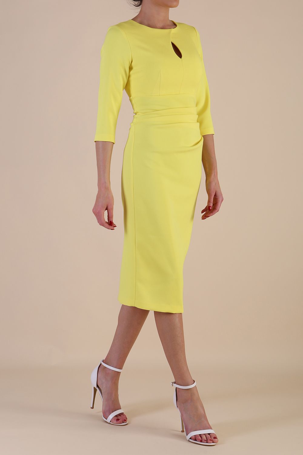 model wearing diva catwalk ubrique pencil dress with a keyhole detail and sleeves in yellow colour