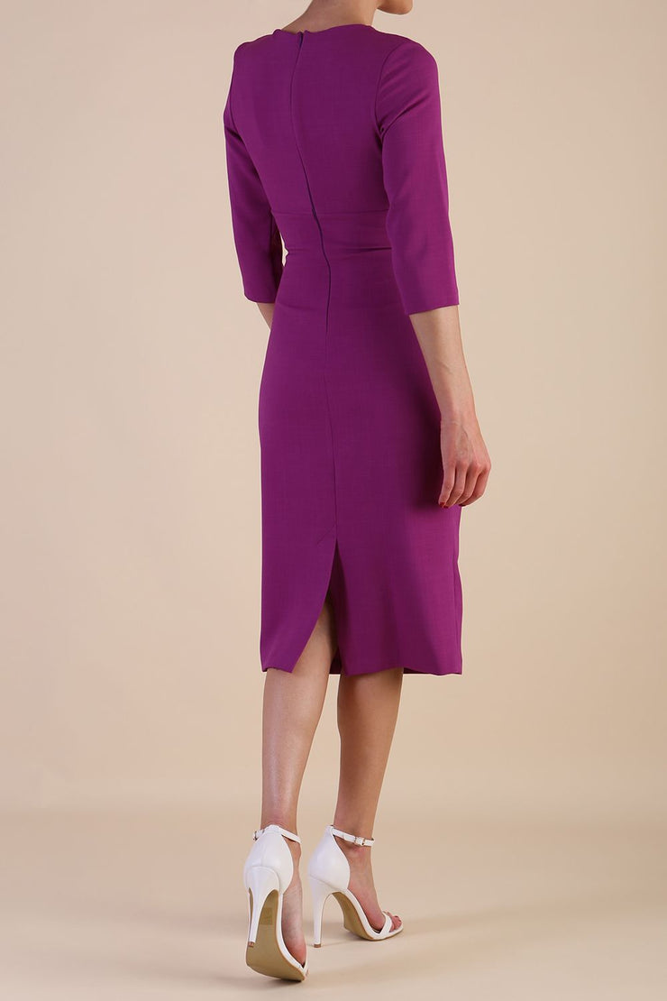 brunette model wearing diva catwalk ubrique pencil dress with a keyhole detail and sleeves in hollyhock purple colour front