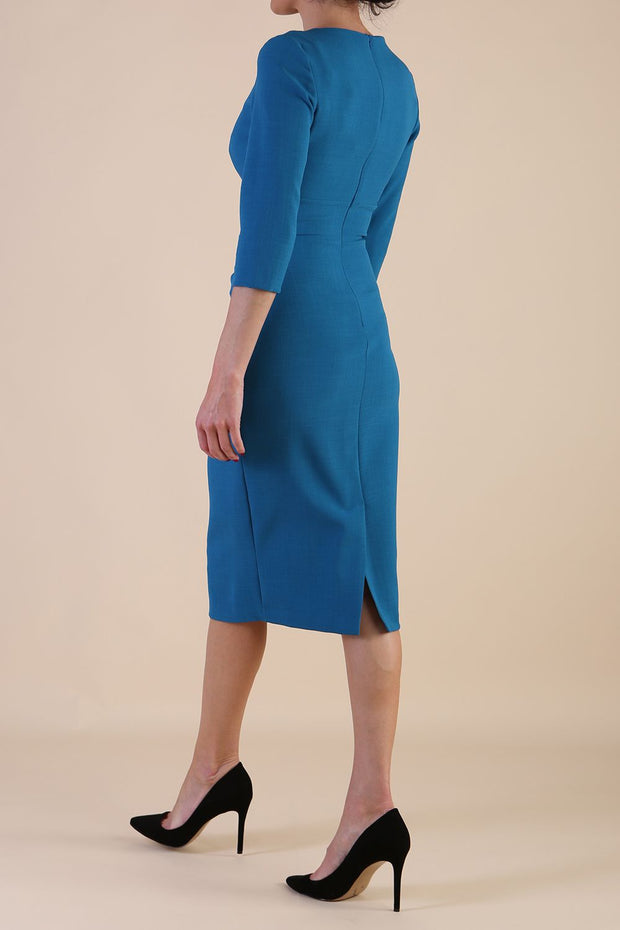 brunette model wearing diva catwalk ubrique pencil dress with a keyhole detail and sleeves in teal colour front