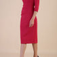 model wearing diva catwalk ubrique pencil dress with a keyhole detail and sleeves in Raspberry Pink